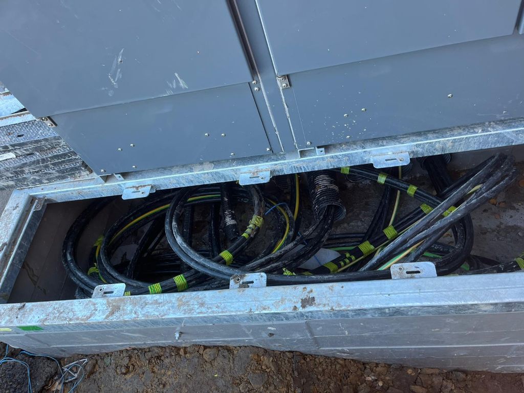 HV cable runs inside the substation base — multiple cables neatly routed through galvanised steel ducting channels